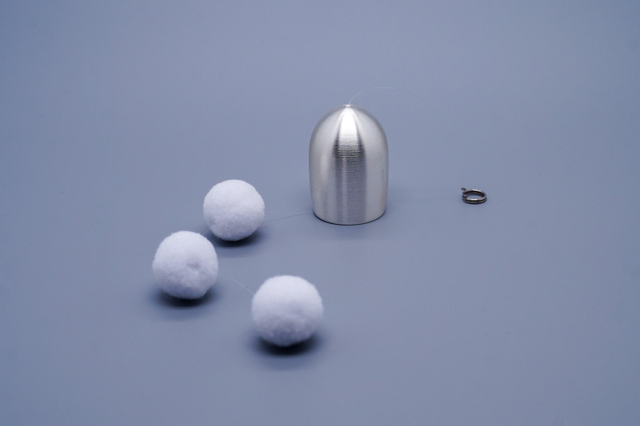Tsubomi brass wind chime in silver with components laid flat including cotton ball clappers and cord ring, by Nousaku, Japan