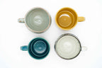 Four Mino-yaki ceramic mugs — CHIPS stackable mugs in green and yellow, Nagara Drops in teal and Aigetsu Shiro in white, made in Japan