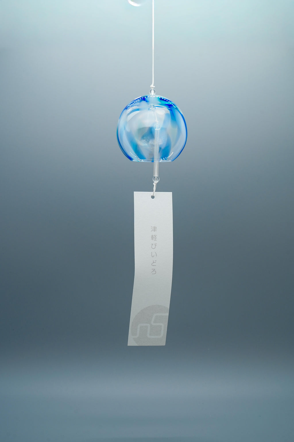 Adelia hand-blown glass wind chime in blue by Tsugaruvidro, Aomori, Japan, hanging with paper strip