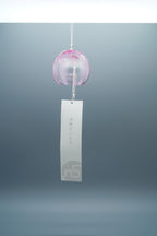 Adelia hand-blown glass wind chime in pink by Tsugaruvidro, Aomori, Japan, hanging with paper strip and brand tag