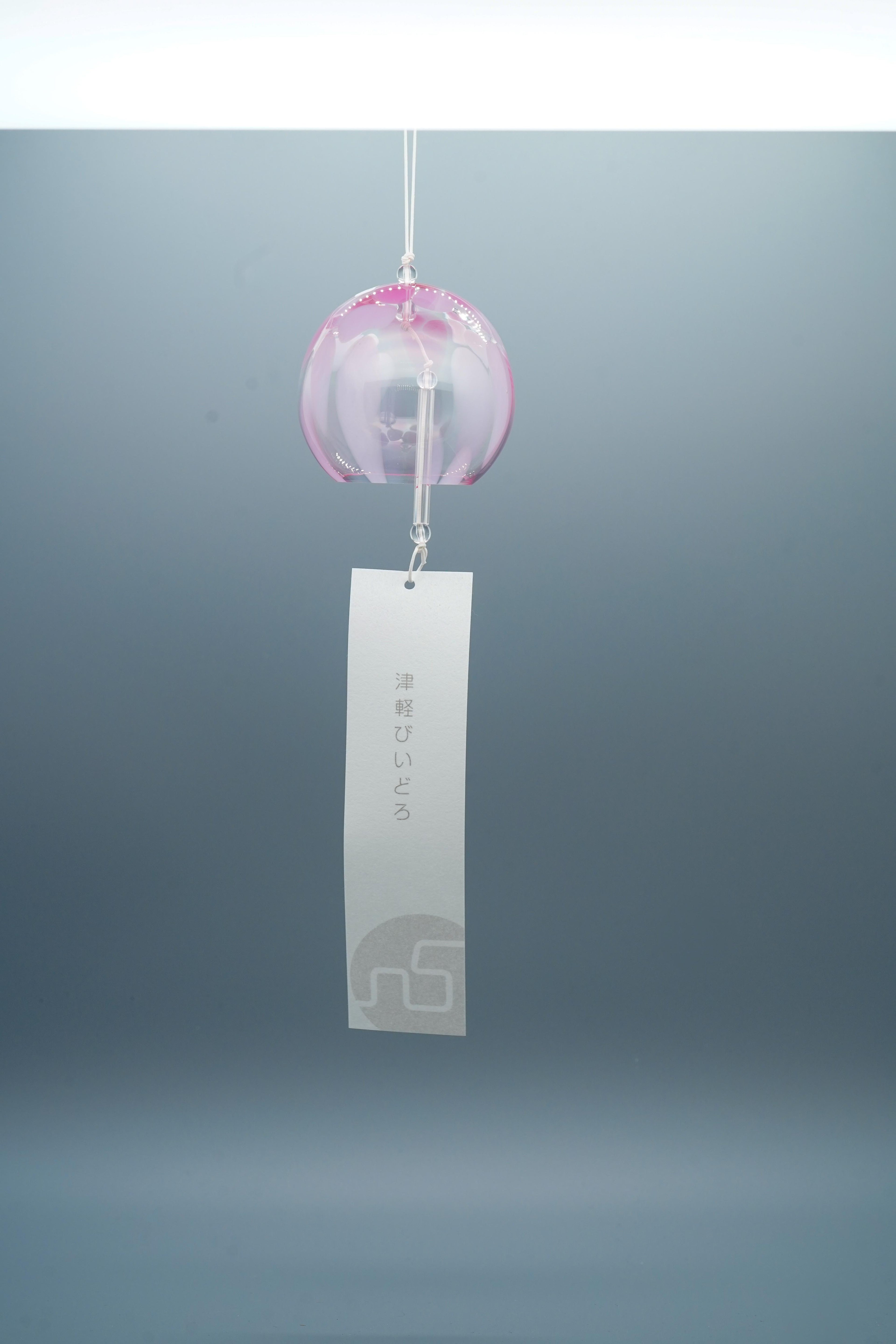 Adelia hand-blown glass wind chime in pink by Tsugaruvidro, Aomori, Japan, hanging with paper strip and brand tag