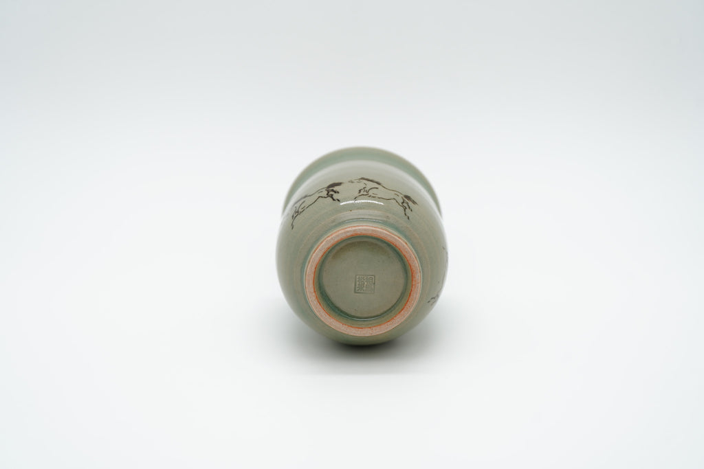 Soma Eight Horses cup on its side, showing a recessed circular base, pale foot ring and square impressed maker’s mark.