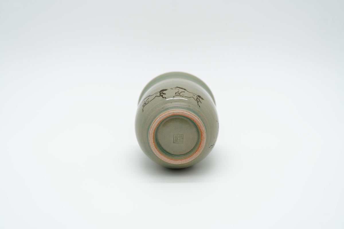 Soma Eight Horses cup on its side, showing a recessed circular base, pale foot ring and square impressed maker’s mark.