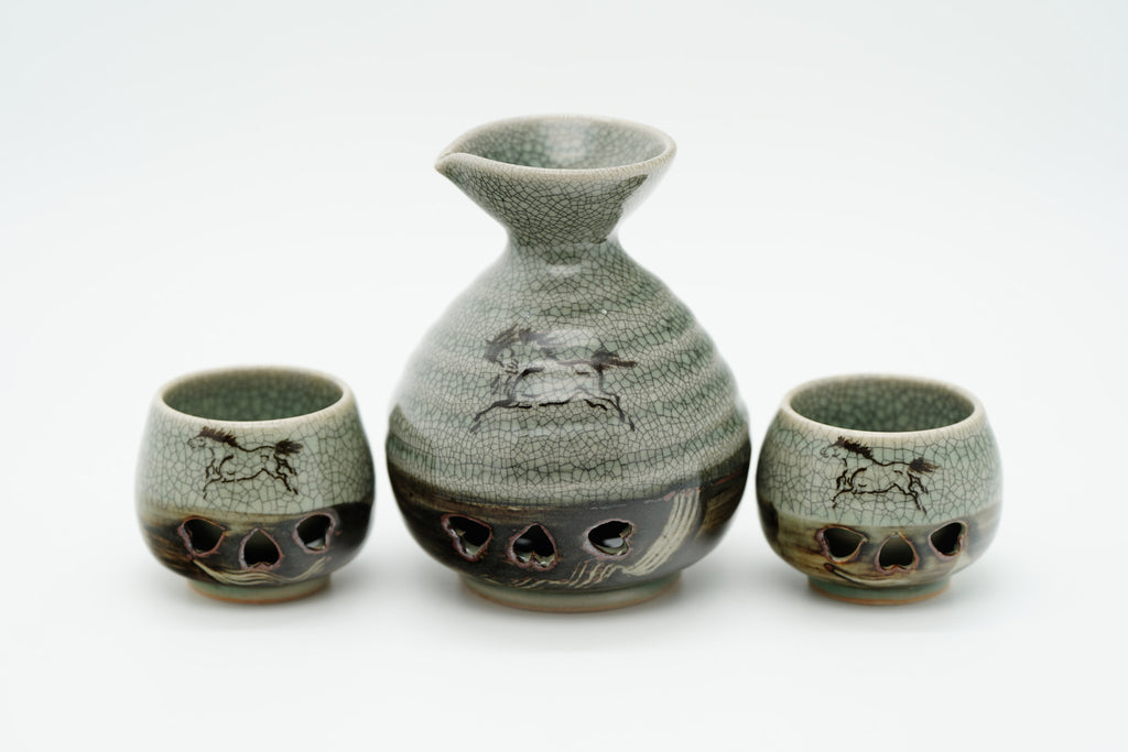 Grey-green crackle-glazed sake carafe and two cups with running horses and heart-shaped openings. 240ml & 30ml. 