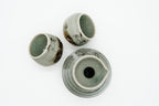 Overhead view of the Soma sake set showing the carafe’s pouring lip and the two cups’ crackled interiors.