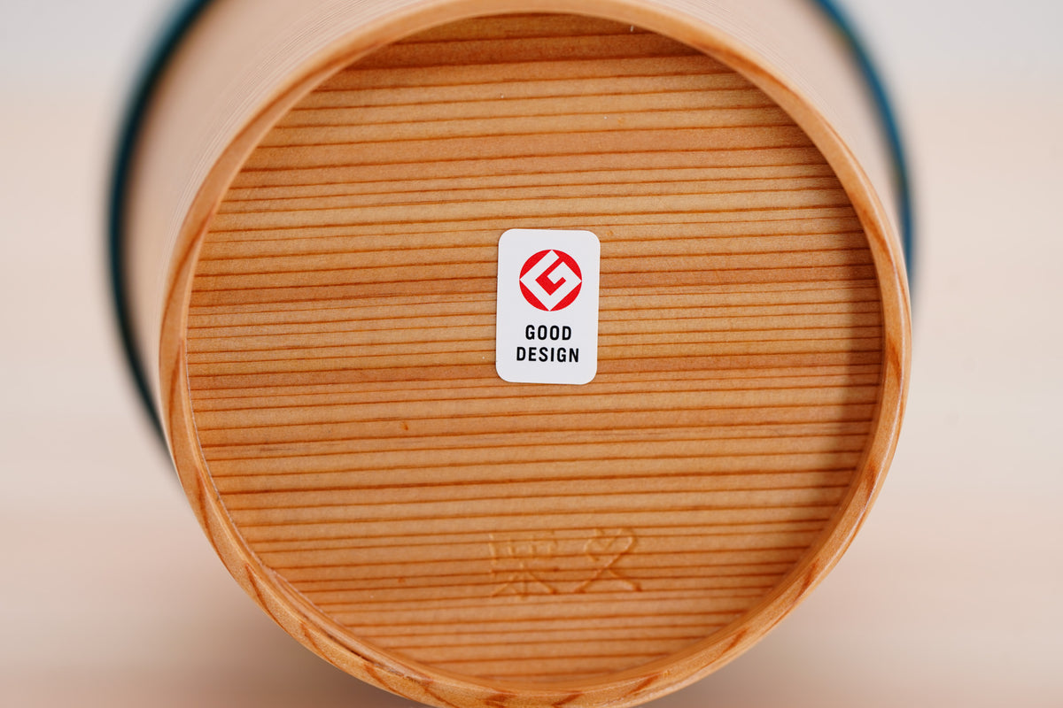 Underside of the Odate Magewappa Ring Cup showing straight grain, an impressed mark and a Good Design sticker.
