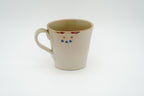 Reverse of the cream Couple Cats mug showing an upside-down cat face just below the rim.