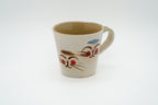 Maruyoshi Couple Cats mug in cream with two smiling cat faces, red cheeks, a pale green interior and a curved handle.